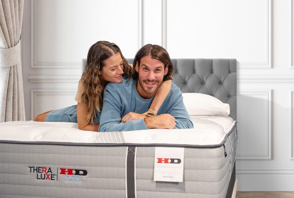 TheraLuxe-HD-couple-aspect-ratio-579-390 Therapedic Theraluxe HD mattress collection at Mattress Mart. Couple testing HD mattress.
